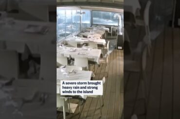 Video shows the moment a storm surge floods the dining room of an Italian seafront restaurant