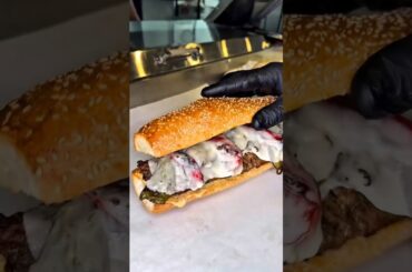 Sandwich with Italian sausage, Giardinera JP Graziano mayonnaise, Cubanella peppers, and cheese.