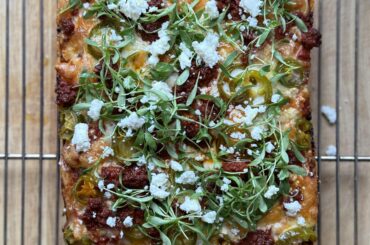 Pork chorizo, pickled jalapeños, queso fresco, and cilantro micro greens.