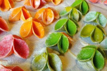 Homemade pasta made with type 0 flour and water-soluble food coloring. Topped with sautéed mushrooms (garlic and parsley) and peas.