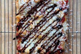 Shallot + garlic confit with Parmesan and balsamic glaze.