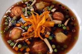 Cherry Braised Short Rib Ravioli, Cherry Broth Consommé, Chive Oil, Carrot, Peas, Mushroom, Crispy Sweet Potato