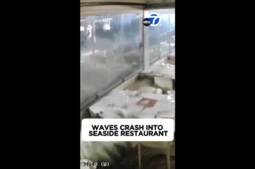 Waves crash into seaside restaurant