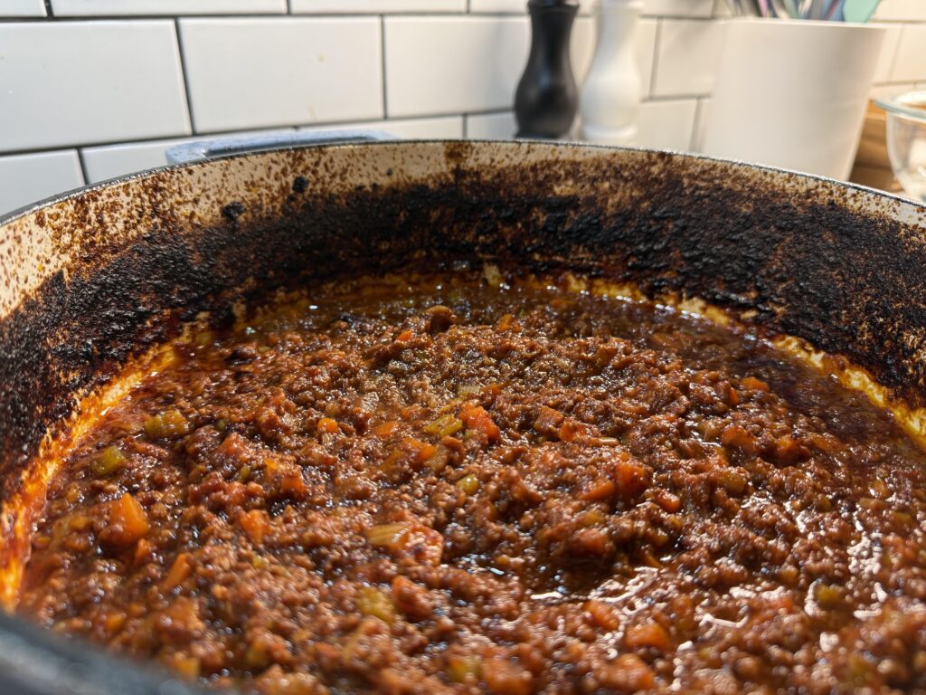 Is this dark buildup avoidable when baking sauce uncovered? Is this dark buildup avoidable when baking sauce uncovered?