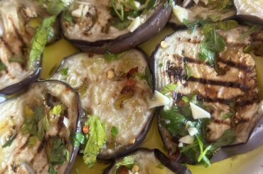 Grilled aubergines with a brine of oil, garlic, and chilli pepper.