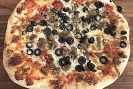 Homemade meatball, onion, and olive sourdough pizza