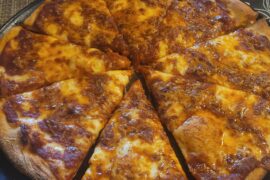 Some homemade pizza and sauce.