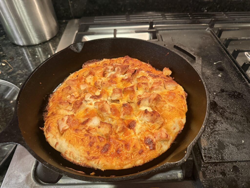 Buffalo chicken pizza cooked in a cast iron skillet