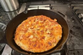 Buffalo chicken pizza cooked in a cast iron skillet