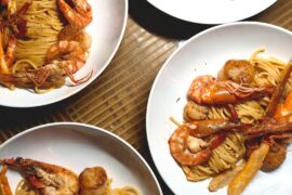 fresh uni spaghetti with crab legs, seared scallops and tiger prawns