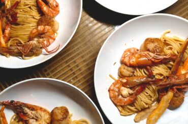 fresh uni spaghetti with crab legs, seared scallops and tiger prawns