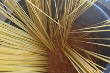 Cooking the pasta in the sauce