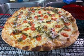 Herbed garlic butter, mozzarella/sharp white mix, halved grape tomatoes, and finished with some pesto and parm.
