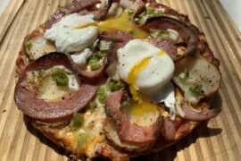 Breakfast Pizza with pork roll, poached eggs, potatoes,peppers,onions