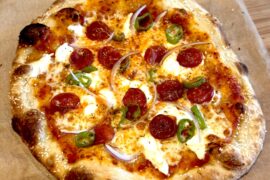 Pepperoni, long hots, red onion, fresh garlic, ricotta, pecorino, hot honey on a sesame seed crust