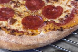 How do you all manage the extra flour on pizza dough?