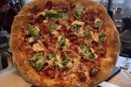 Tomato pie with pepperoni, stracciatella, spicy candied garlic, basil and pecorino