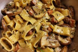 Calamarata with mushrooms, spicy salsiccia, onion, garlic, cream, white wine, parsley and black pepper