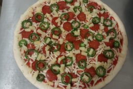 Three topping pizza on a Saturday night.