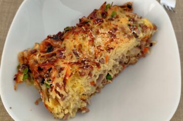 Baked tagliolini with mushrooms peas and ground beef