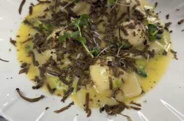 Ricotta and hazelnut ravioli with grated fresh truffles and sage butter emulsion.