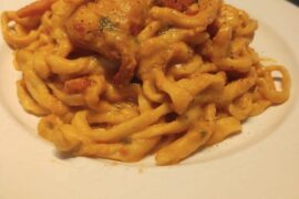 Handmade pasta with Vodka-flambéed prawns, sun-dried tomatoes, and a rich Bottarga cream. [OC]