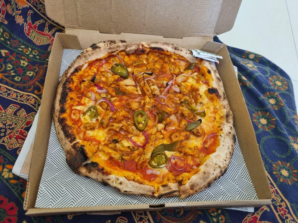 Peri peri chicken, red onions, jalapeño and mozzarella pizza