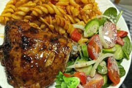 Pasta with baked chicken wings in mustard and salad