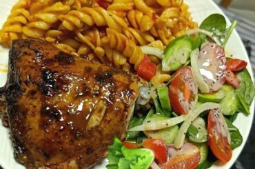 Pasta with baked chicken wings in mustard and salad