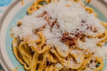 Handmade fettuccine with (handmade) sausage tomato sauce and pecorino cheese