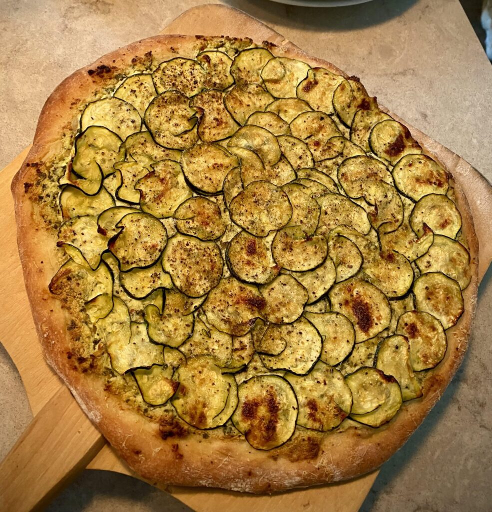 Zucchini Pizza on the barbecue with a pizza stone