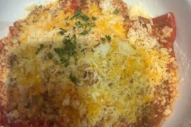 meat ravioli, bologna sauce with bacon, corn, parmesan cheese