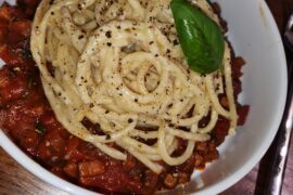 Cheater cacio e pepe buccatini over bacon mushroom ragu