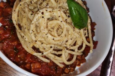 Cheater cacio e pepe buccatini over bacon mushroom ragu