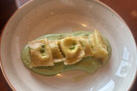 Cacio e Pepe stuffed agnolotti with citrus green pea cream.
