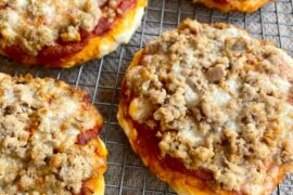 made little pizzas with mozzarella, sausage, and fresh rosemary