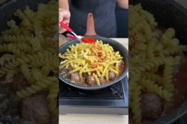 Creamy pasta with meatballs in a pot