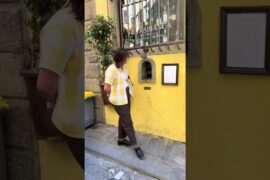 Woman orders an Aperol Spritz at a wine window in Florence, Italy!