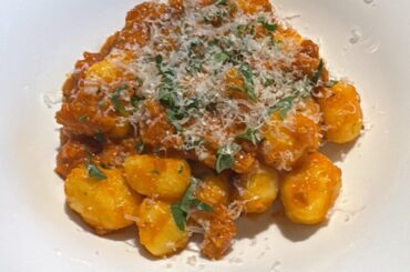 Homemade gnocchi in red bell pepper sauce with sausage