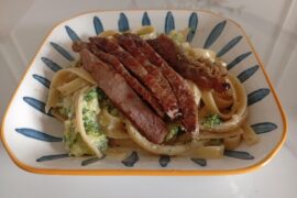 Broccoli Alfredo Fettuccine with a steak on top