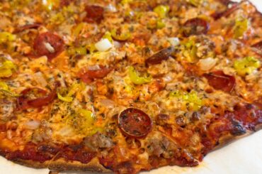 Homemade sausage, pepperoni, onion, and pepperoncini