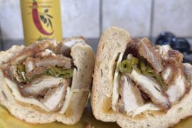 Chicken cutlet with sharp provolone, fried long hots and chili oil on a Liscio’s torpedo roll