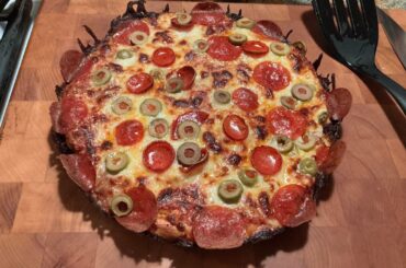 Pan pizza with two kinds of pep and sliced green pimento stuffed olives.