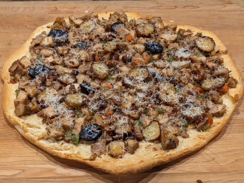 Roasted chicken, potato and vegetable pizza on croisant crust