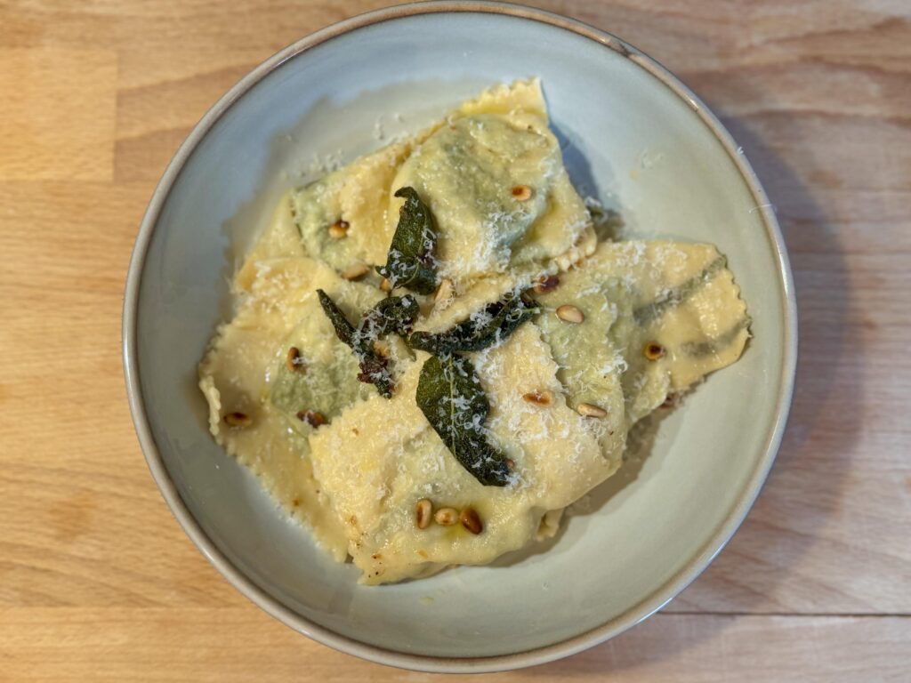 Spinach & Ricotta Ravioli with a Sage Lemon Butter & Toasted Pine Nuts. The pasta is laminated with sage leaves too