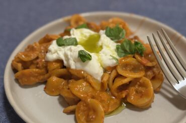 Vodka pasta with beef and burrata with basil oil.