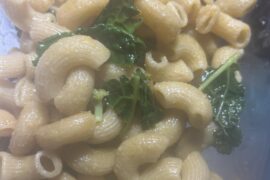 Whole wheat large elbow pasta, kale, little bit of broccoli, black peppercorns at the bottom, olive oil, garlic, nutritional yeast