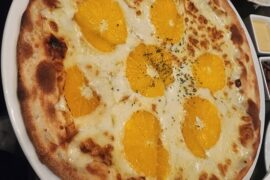 I am in a restaurant that puts orange slices on their pizza!!!