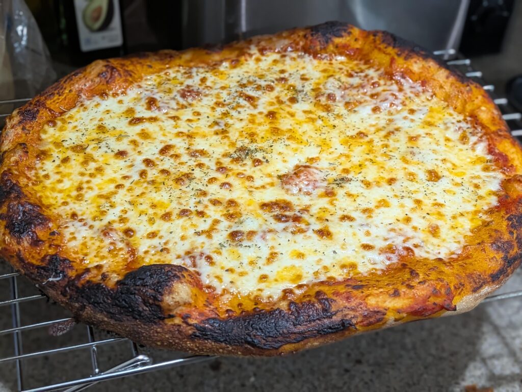 Let the pizza cook a little more than normal, turns out I've been undercooking my cheese slightly!