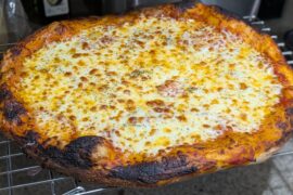 Let the pizza cook a little more than normal, turns out I've been undercooking my cheese slightly!